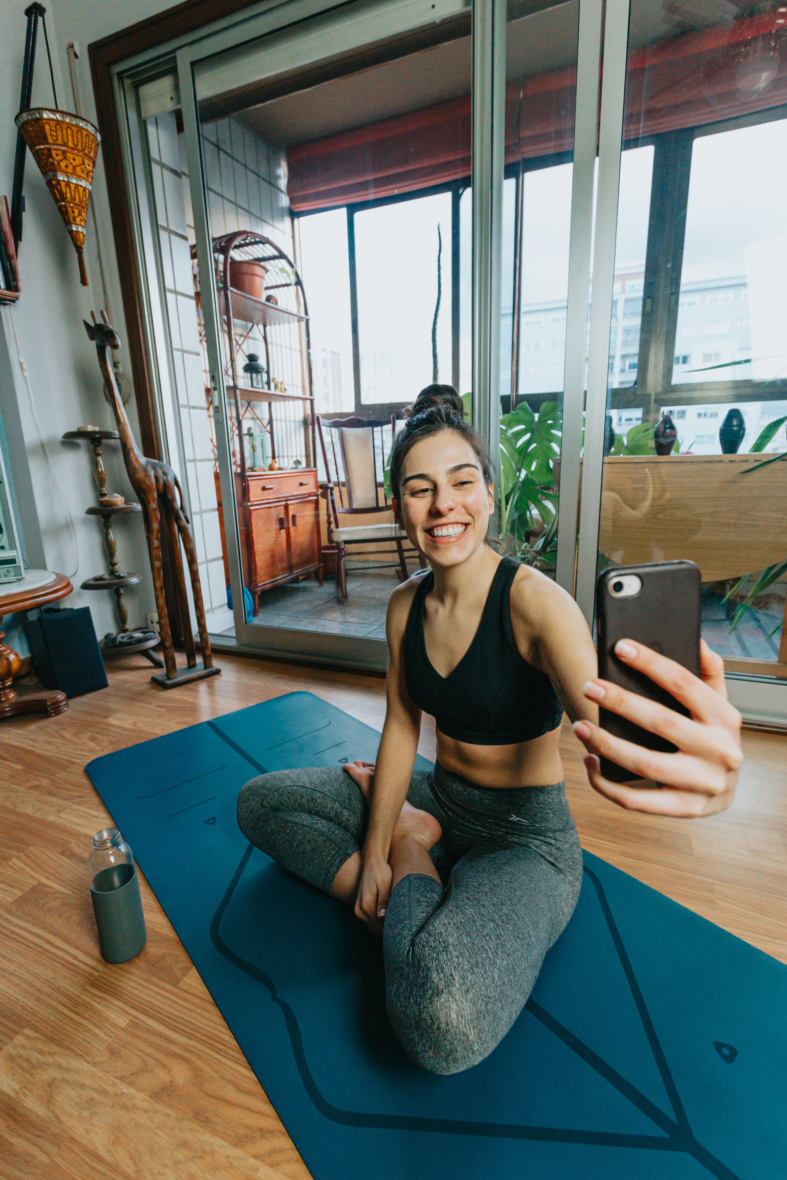 files/woman-sits-cross-legged-smiling-at-their-cell-phone.jpg